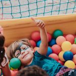 child in multi coloured ball pit