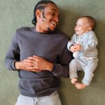 dad and baby lying down looking at each other